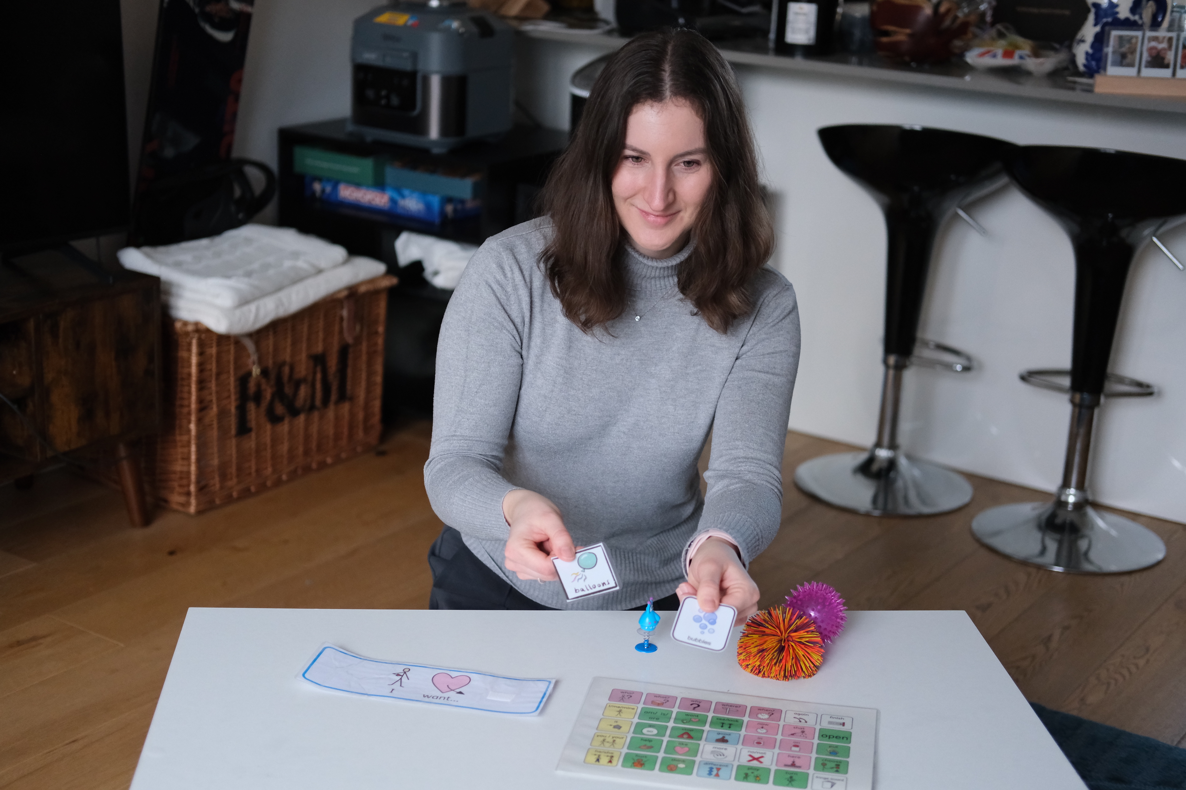 Nina demonstrating therapy techniques with picture cards